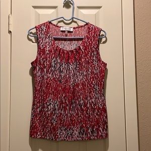 Red, black and white sleeveless blouse.